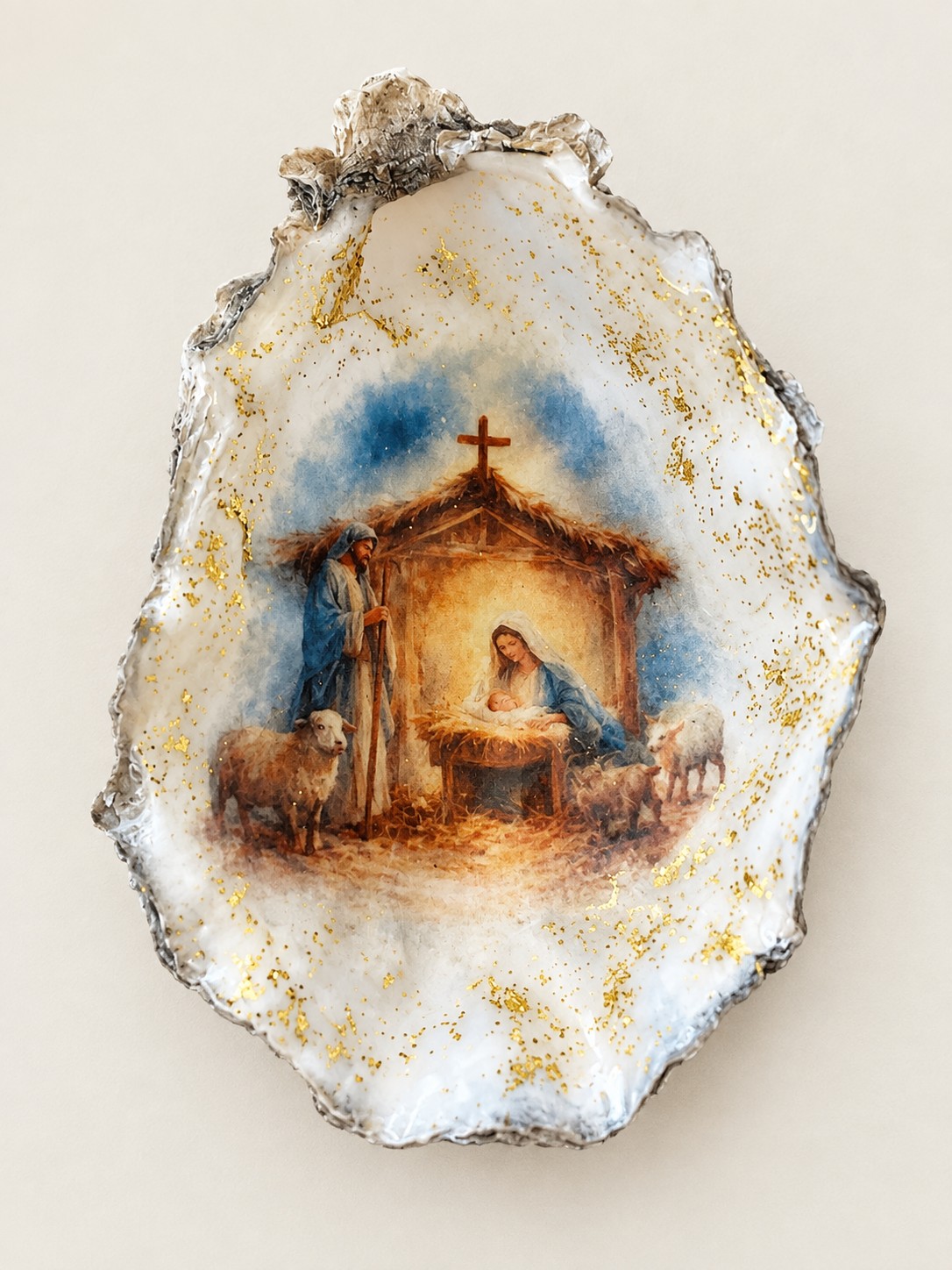 Nativity scene inside an oyster shell with gold flecks